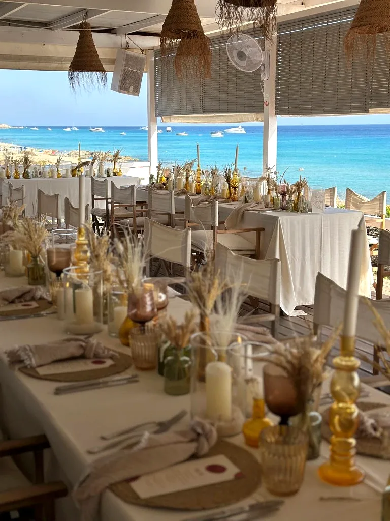 Beach wedding tables with yachts in the bay